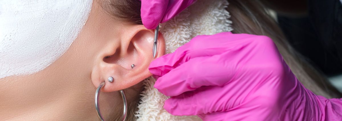 Woman getting her ear pierced